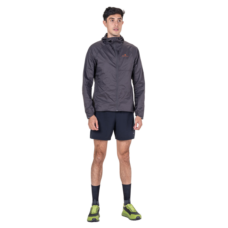 Front view of a model wearing the Ronhill Men's Tech All-Terrain Jacket in the Oxide/Ronhill Red colourway.