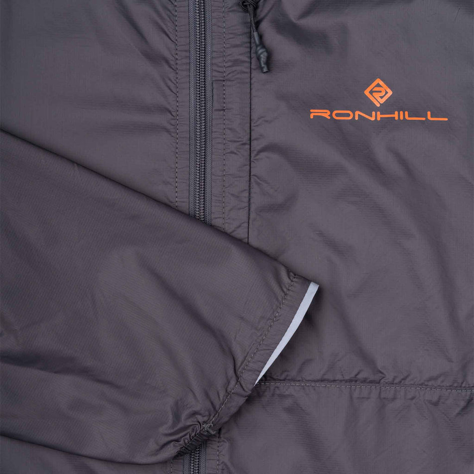 Close-up view of the front of the Ronhill Men's Tech All-Terrain Jacket in the Oxide/Ronhill Red colourway.