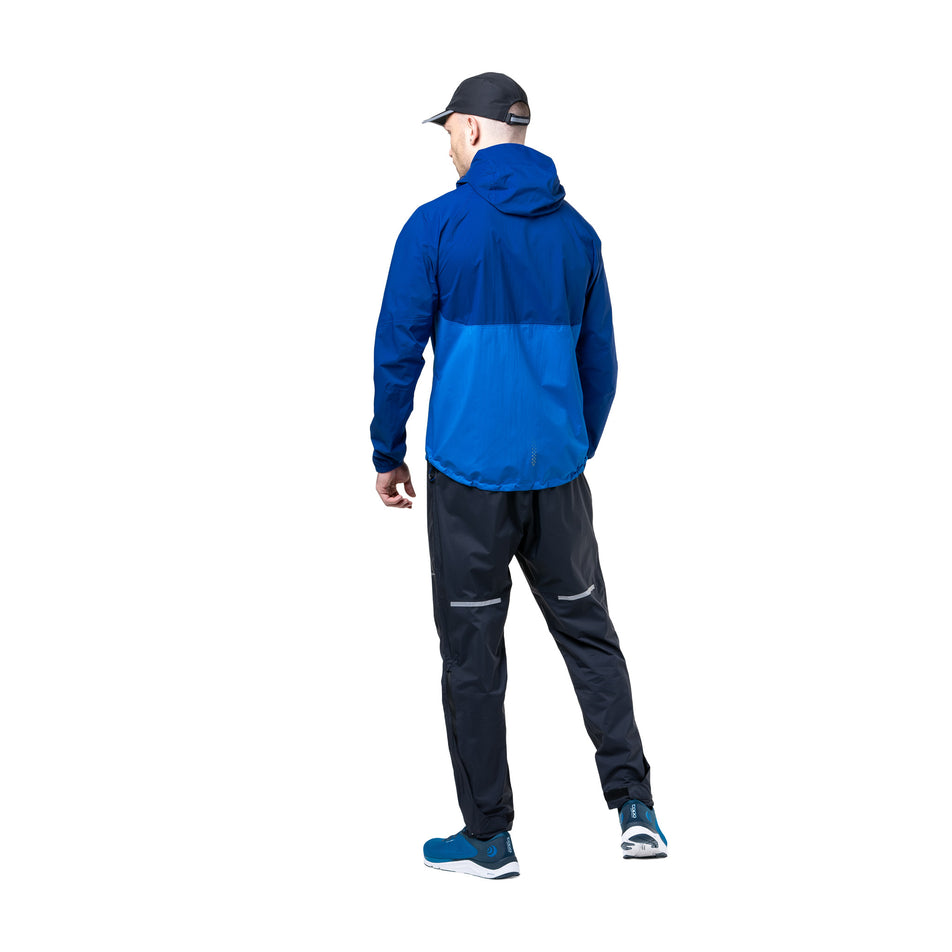 Back view of a model wearing the Ronhill Men's Tech Storm Jacket in the Ocean/Electric Blue colourway. (8742825853090)