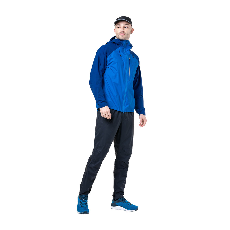 Front view of a model wearing the Ronhill Men's Tech Storm Jacket in the Ocean/Electric Blue colourway. (8742825853090)
