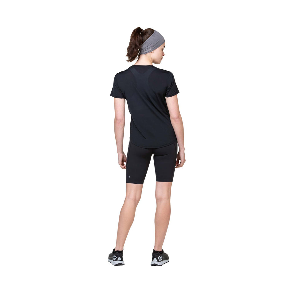 Back view of a model wearing the Ronhill Women's Tech S/S Tee in the All Black colourway. (8564967800994)