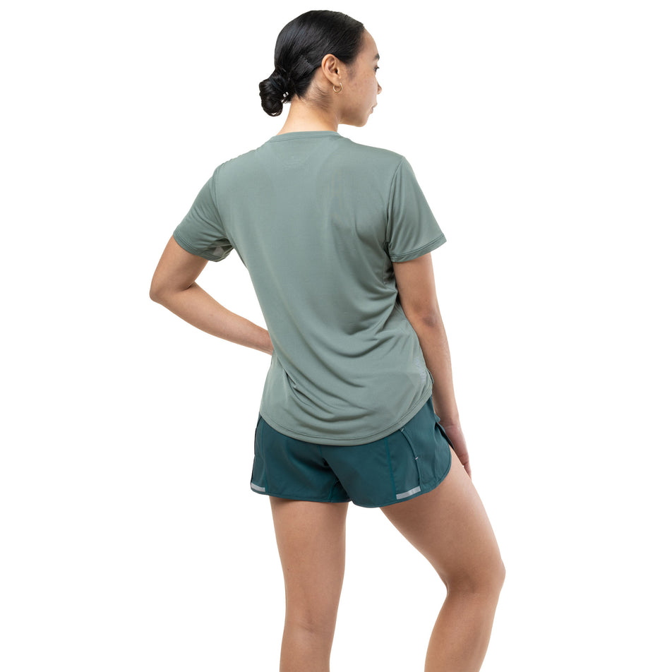 Back view of a model wearing the Ronhill Women's Tech S/S Tee in the Laurel/Seafoam colourway.