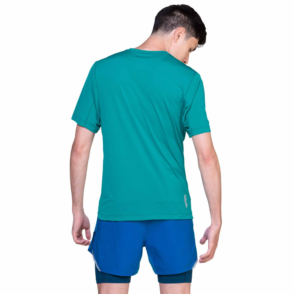 Back view of a model wearing the Ronhill Men's Tech S/S Tee in the Deep Laguna/Seafaring colourway. (8565248295074)