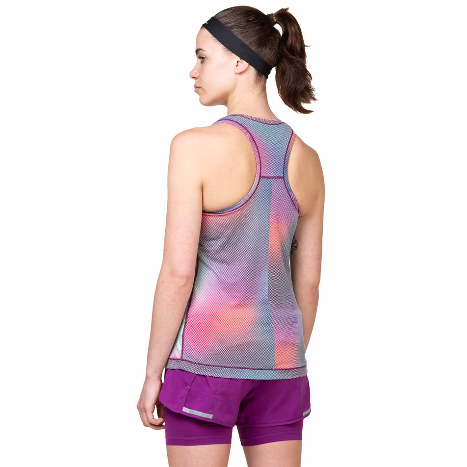Back view of a model wearing the Ronhill Women's Tech Golden Hour Vest in the Aurora Glow colourway. (8564966031522)