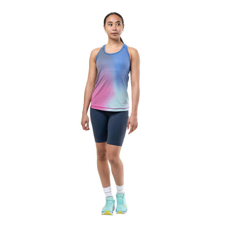 Front view of a model wearing the Ronhill Women's Tech Golden Hour Vest in the Exuberance Merge colourway.