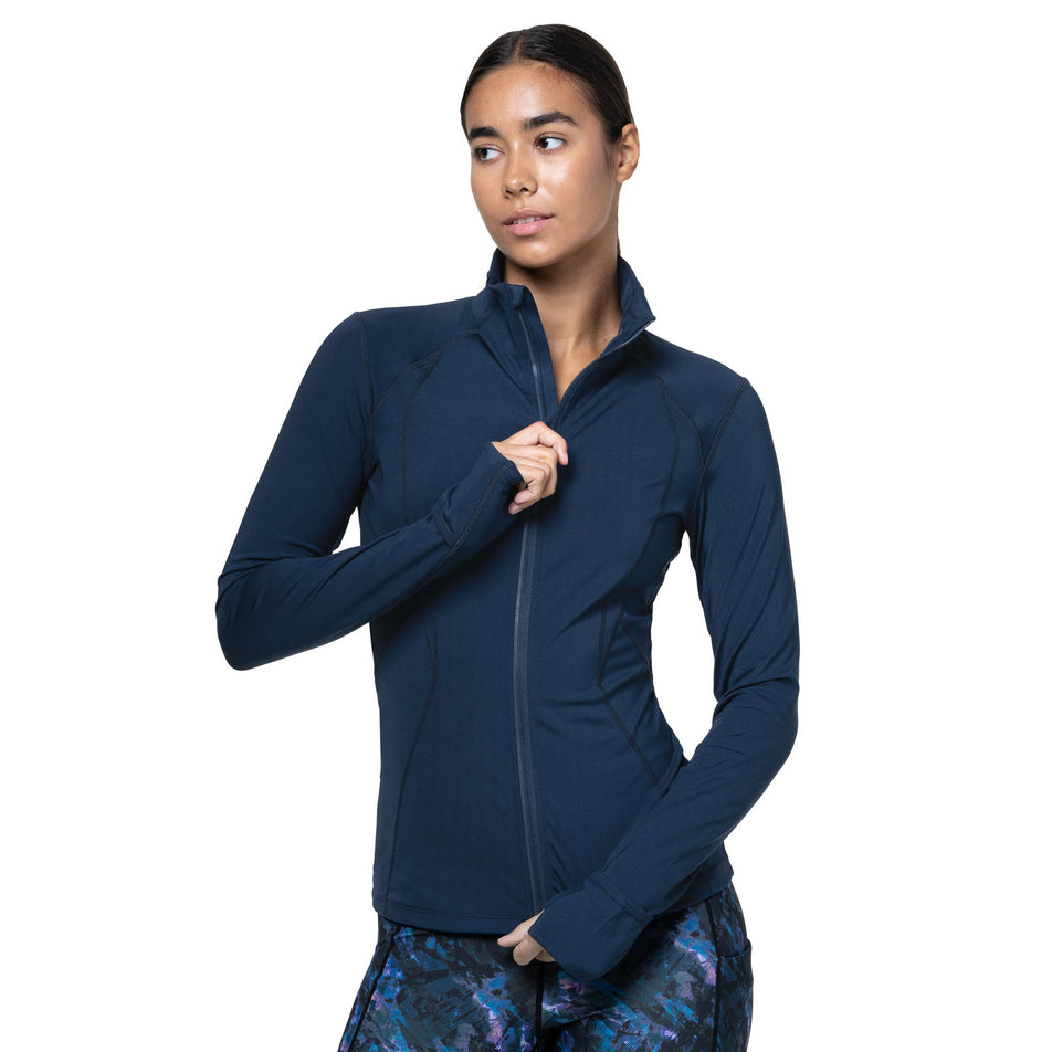 Front view of a model wearing the Ronhill Women's Tech Contour Jacket in the Dark Navy colourway. (8742703693986)