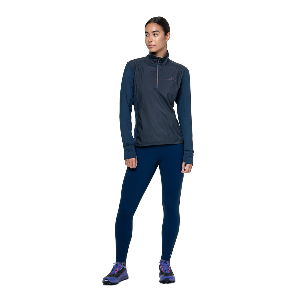 Front view of a model wearing the Ronhill Women's Tech Wind-Block 1/2 Zip in the Dark Navy/Dusty Tulip colourway. (8742677414050)