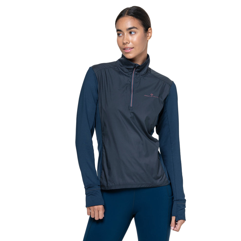 Front view of a model wearing the Ronhill Women's Tech Wind-Block 1/2 Zip in the Dark Navy/Dusty Tulip colourway. (8742677414050)