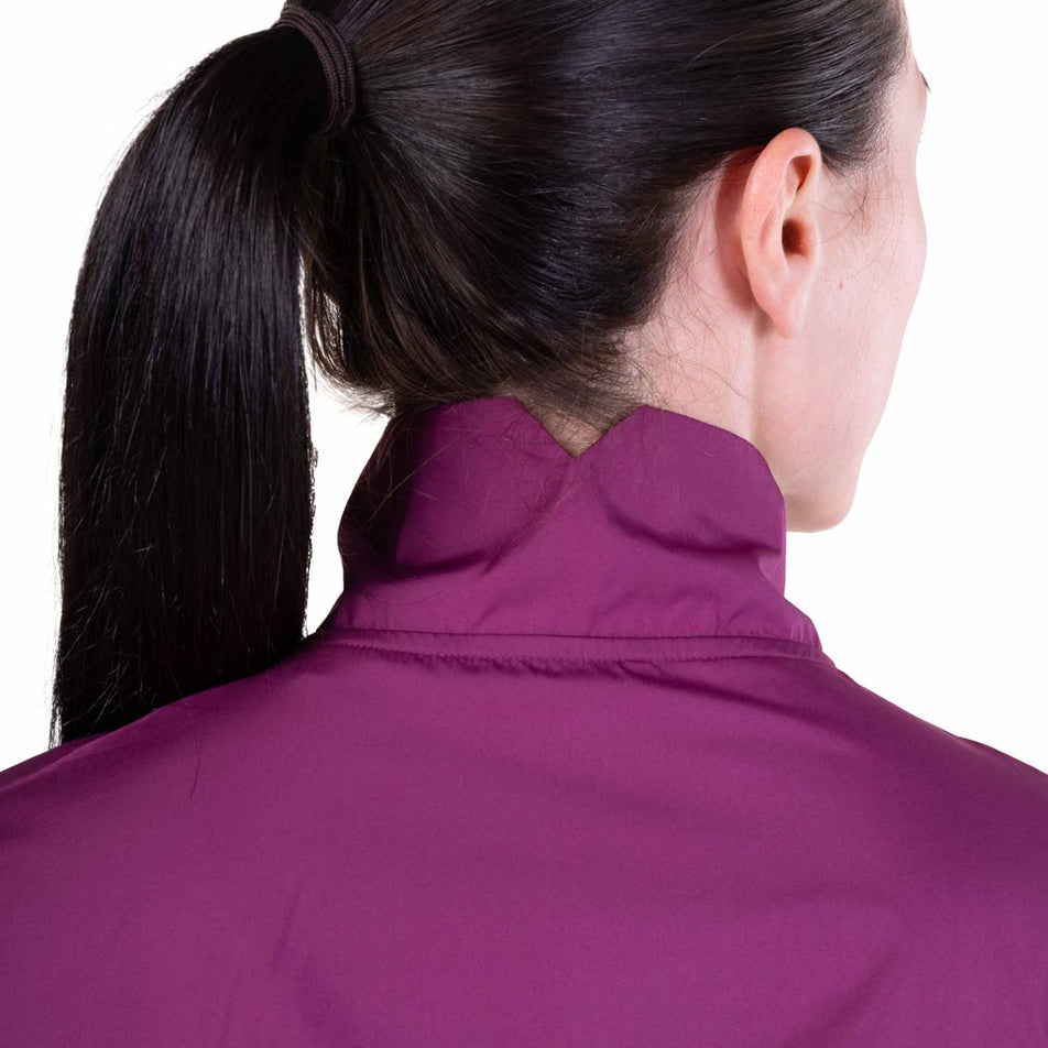 Back view of a model wearing the Ronhill Women's Tech Wind-Block 1/2 Zip in the Blackcurrant colourway.