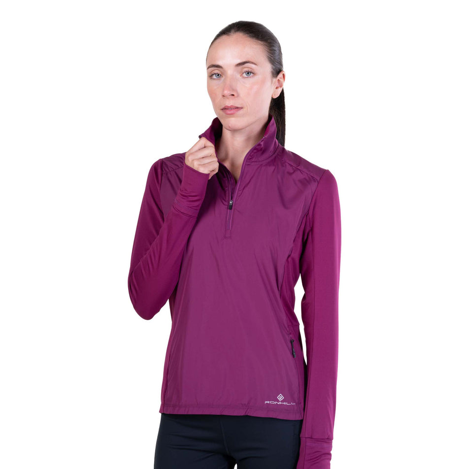 Front view of a model wearing the Ronhill Women's Tech Wind-Block 1/2 Zip in the Blackcurrant colourway.