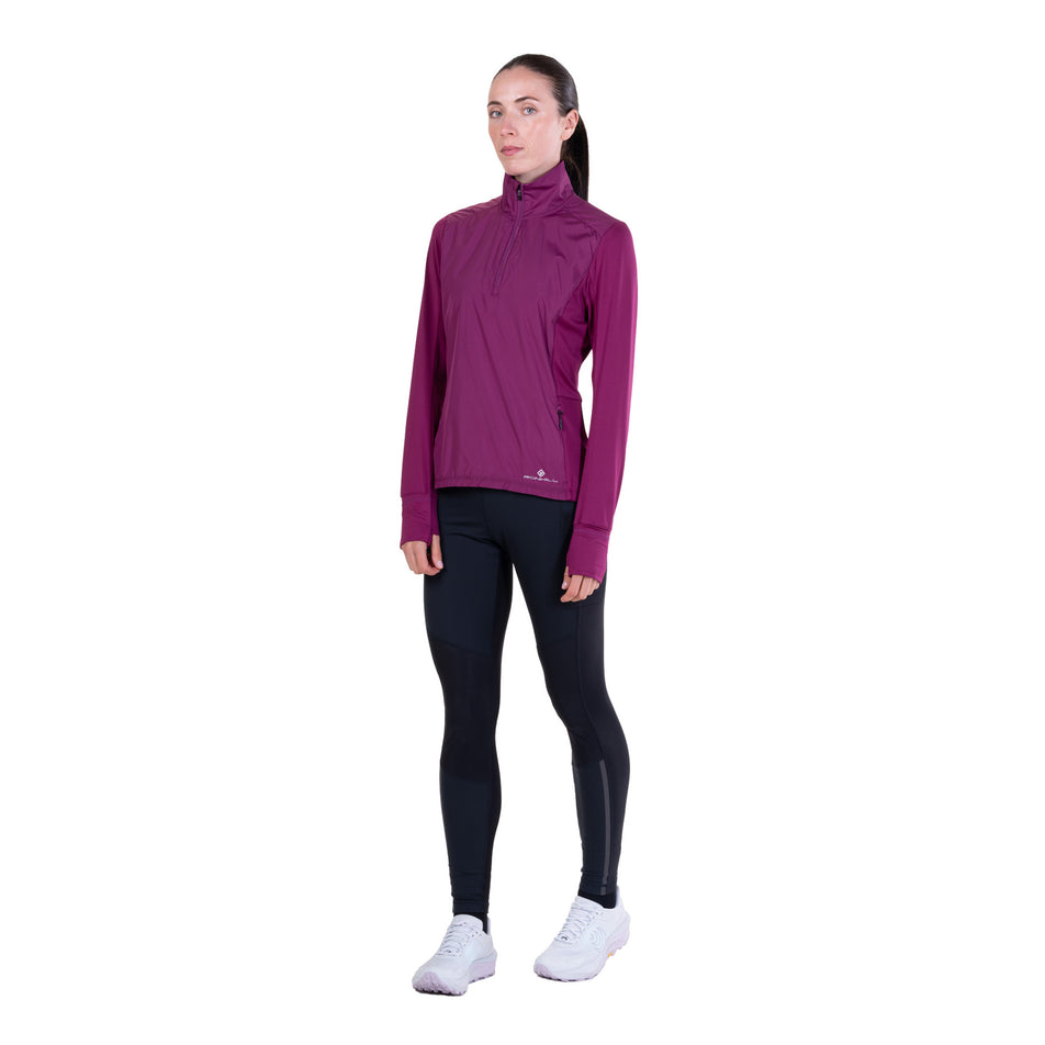 Front view of a model wearing the Ronhill Women's Tech Wind-Block 1/2 Zip in the Blackcurrant colourway.