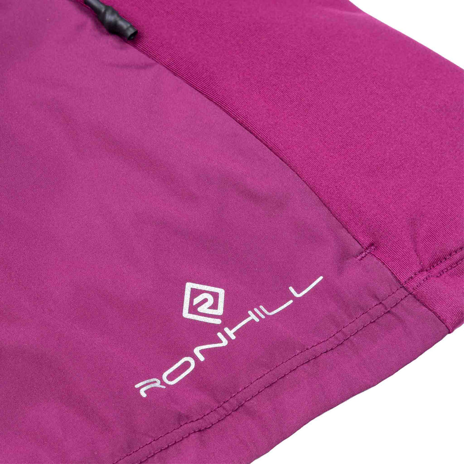 The Ronhill logo on the Ronhill Women's Tech Wind-Block 1/2 Zip in the Blackcurrant colourway.