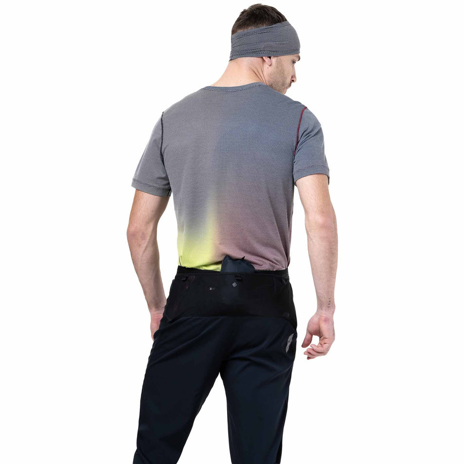 Back view of a model wearing the Ronhill Men's Tech All-Terrain Trackster in the All Black colourway. (8742887096482)