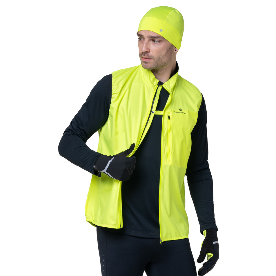 Front view of a model wearing the Ronhill Men's Core Gilet in the Fluo Yellow/Black colourway. (8748546195618)