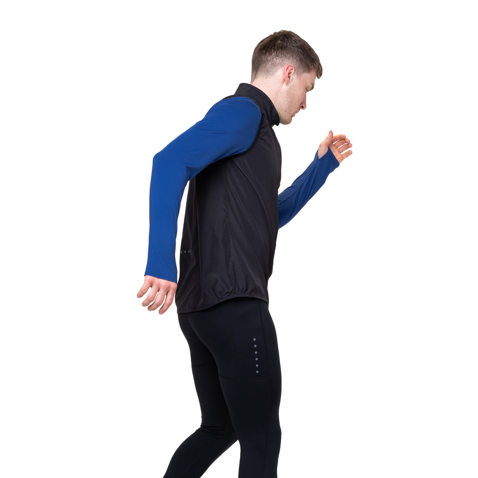 Angled view of a model wearing the Ronhill Men's Core Gilet in the Black/Bright White colourway.