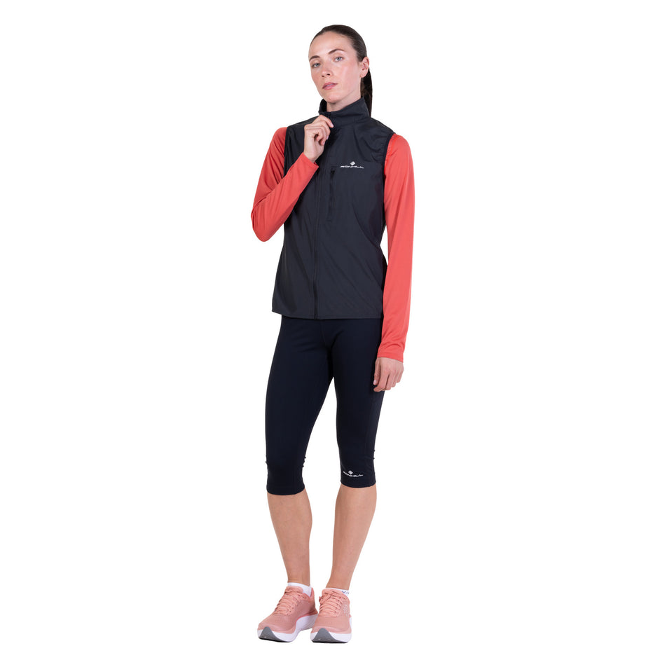 Front view of a model wearing the Ronhill Women's Core Gilet in the Black/Bright White colourway.