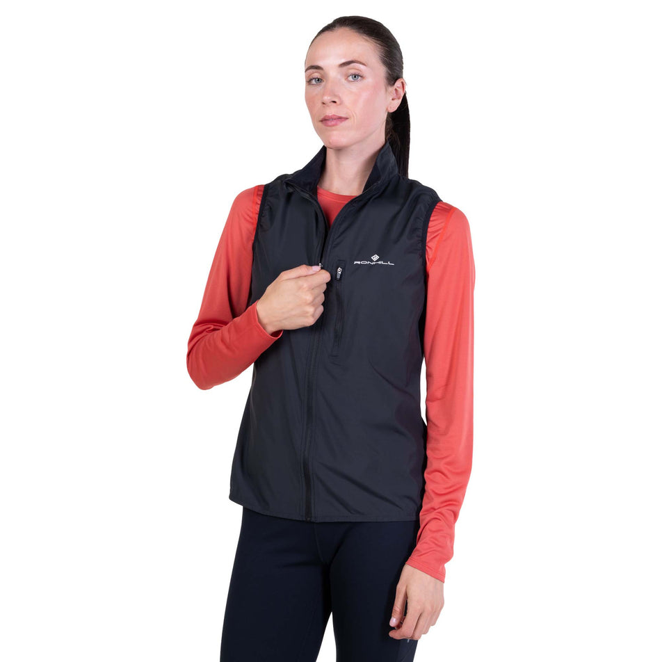Front view of a model wearing the Ronhill Women's Core Gilet in the Black/Bright White colourway.