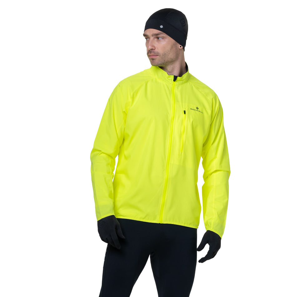 Front view of a model wearing the Ronhill Men's Core Jacket in the Fluo Yellow/Black colourway. (8742893551778)