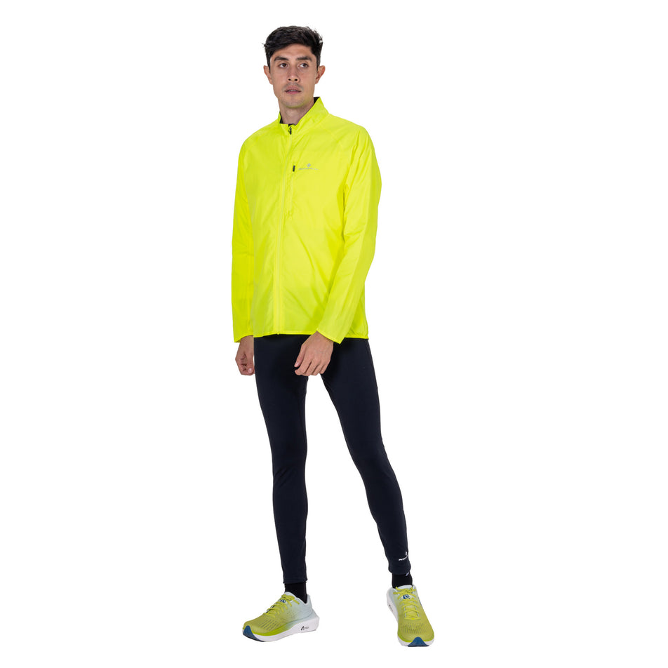 Front view of a model wearing the Ronhill Men's Core Jacket in the Fluo Zest colourway.