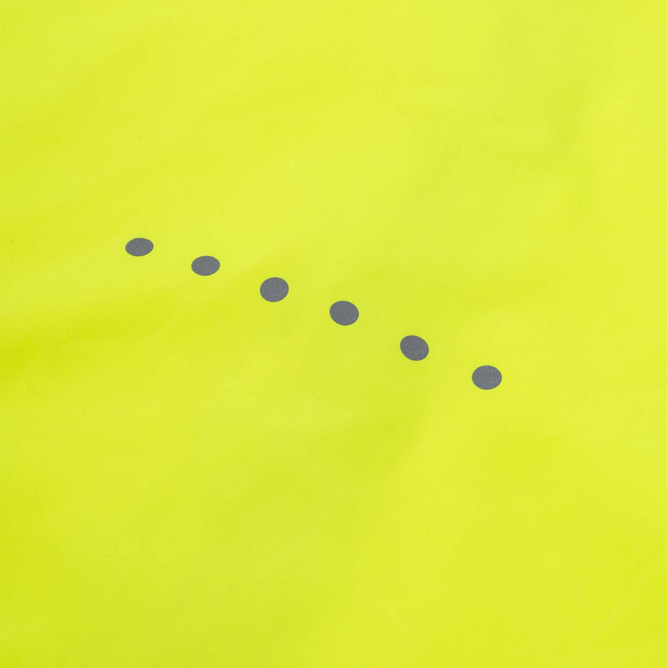 Close-up view of the reflective dots on back of the Ronhill Men's Core Jacket in the Fluo Zest colourway.