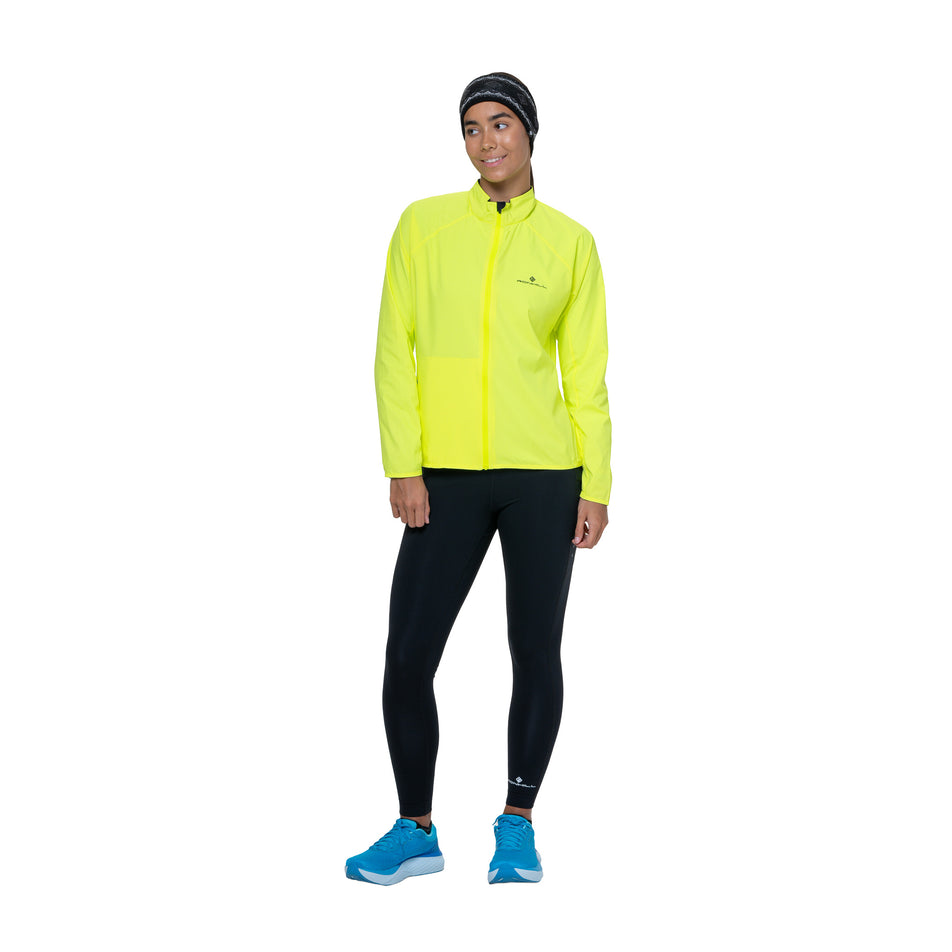 Front view of a model wearing the Ronhill Women's Core Jacket in the Fluo Yellow/Black colourway. (8742755369122)