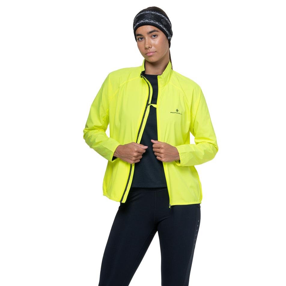 Front view of a model wearing the Ronhill Women's Core Jacket in the Fluo Yellow/Black colourway. (8742755369122)