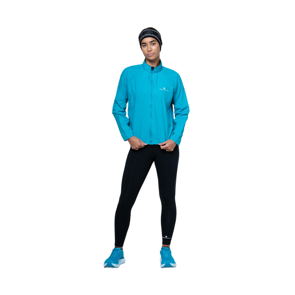 Front view of a model wearing the Ronhill Women's Core Jacket in the Azure/Bright White colourway. (8747610931362)