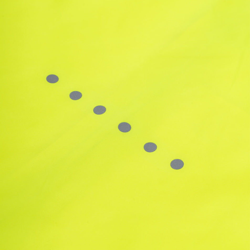 Close-up view of the reflective details on the back of the Ronhill Women's Core Jacket in the Fluo Zest colourway.