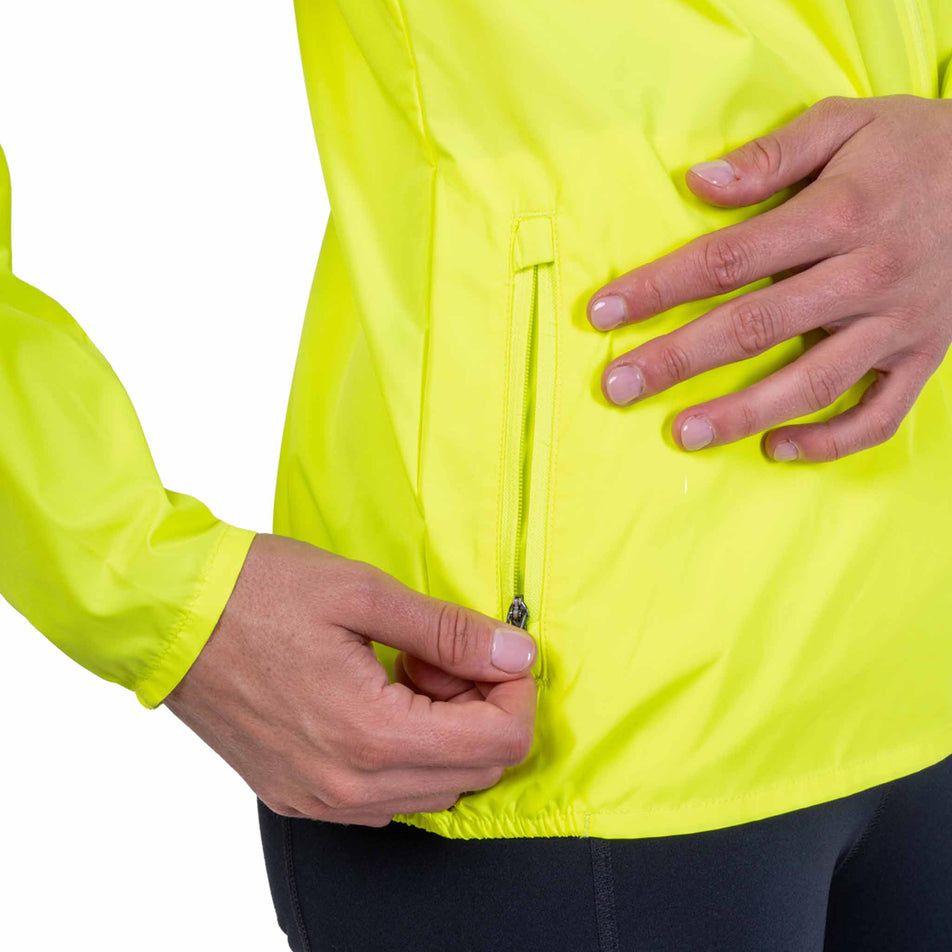The zip pocket on the side of the Ronhill Women's Core Jacket in the Fluo Zest colourway.