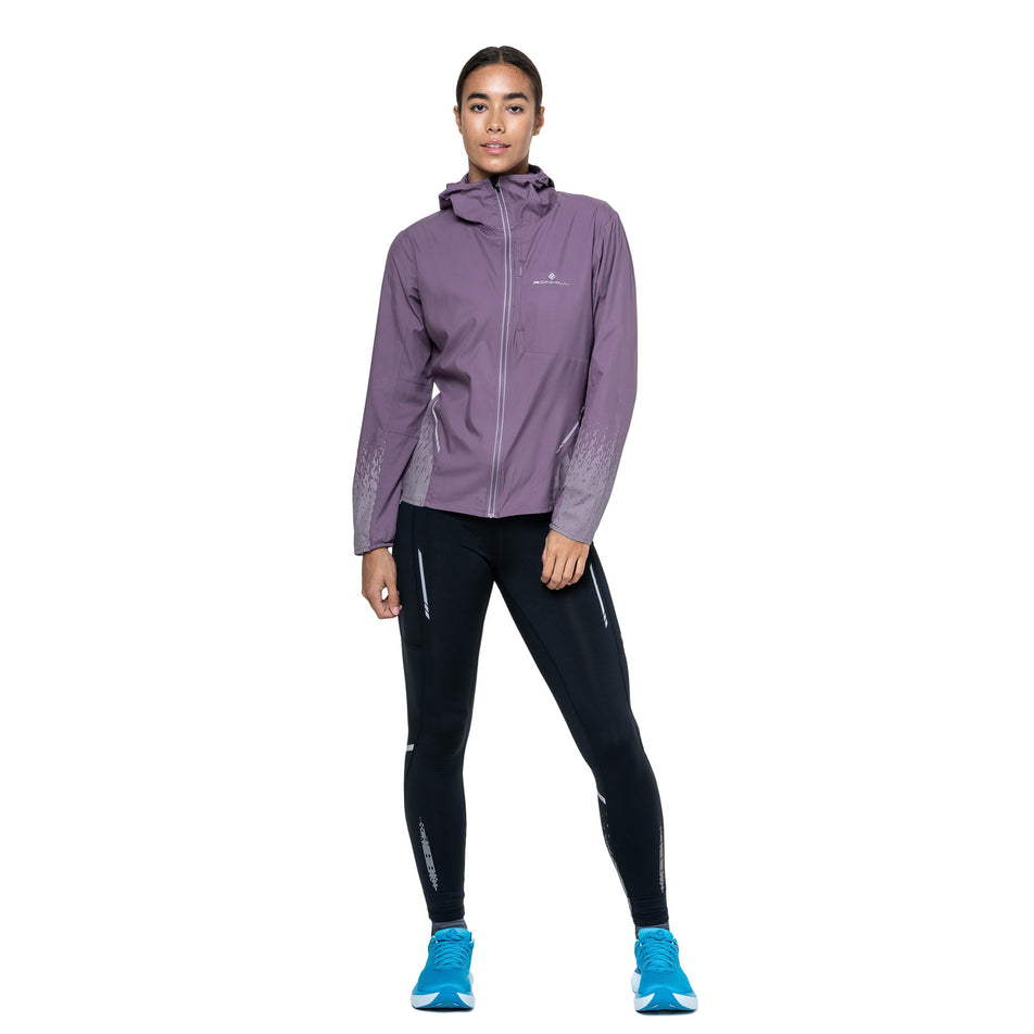 Front view of a model wearing the Ronhill Women's Tech Reflect Jacket in the Dark Iris/Reflect colourway. (8742187663522)