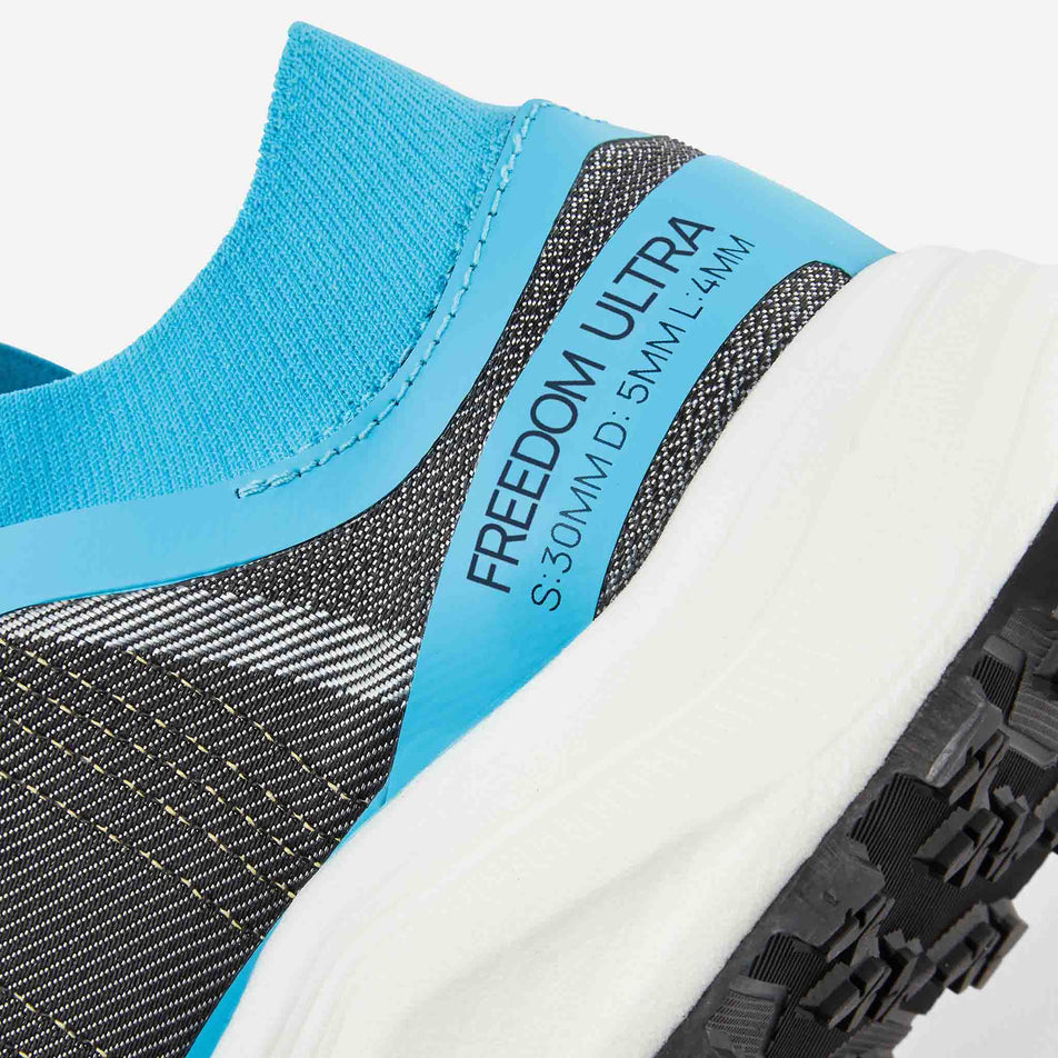 Medial view of the right shoe from a pair of Ronhill Men's Freedom Ultra Running Shoes in the Blue Atoll colourway.