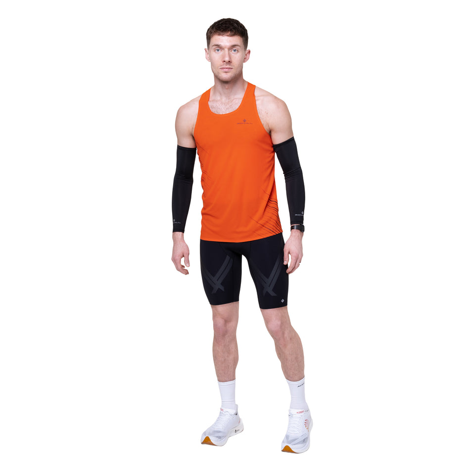 Front view of a model wearing the Ronhill Men's Tech Race Half Tight in the All Black colourway.