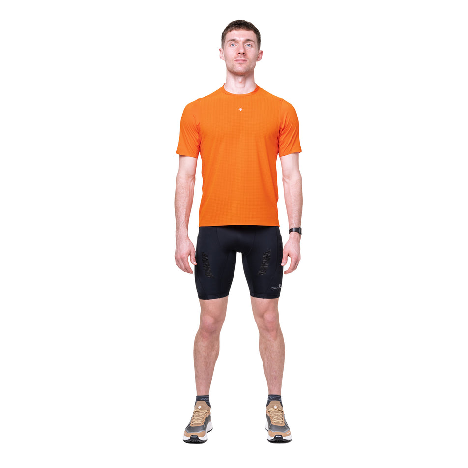 Front view of a model wearing the Ronhill Men's Tech All-Terrain S/S Tee in the Ronhill Red colourway.