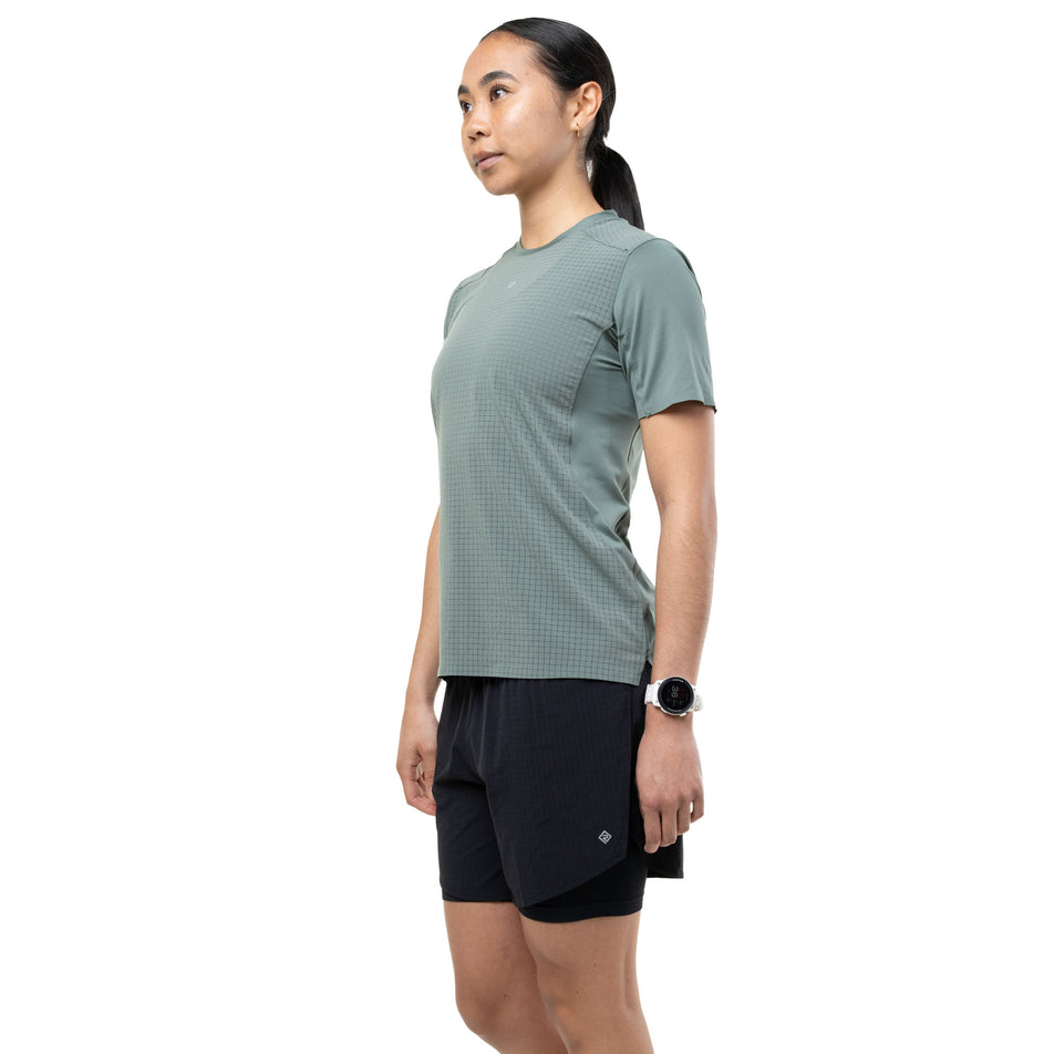 Angled view of a model wearing the Ronhill Women's Tech All-Terrain S/S Tee in the Laurel colourway.