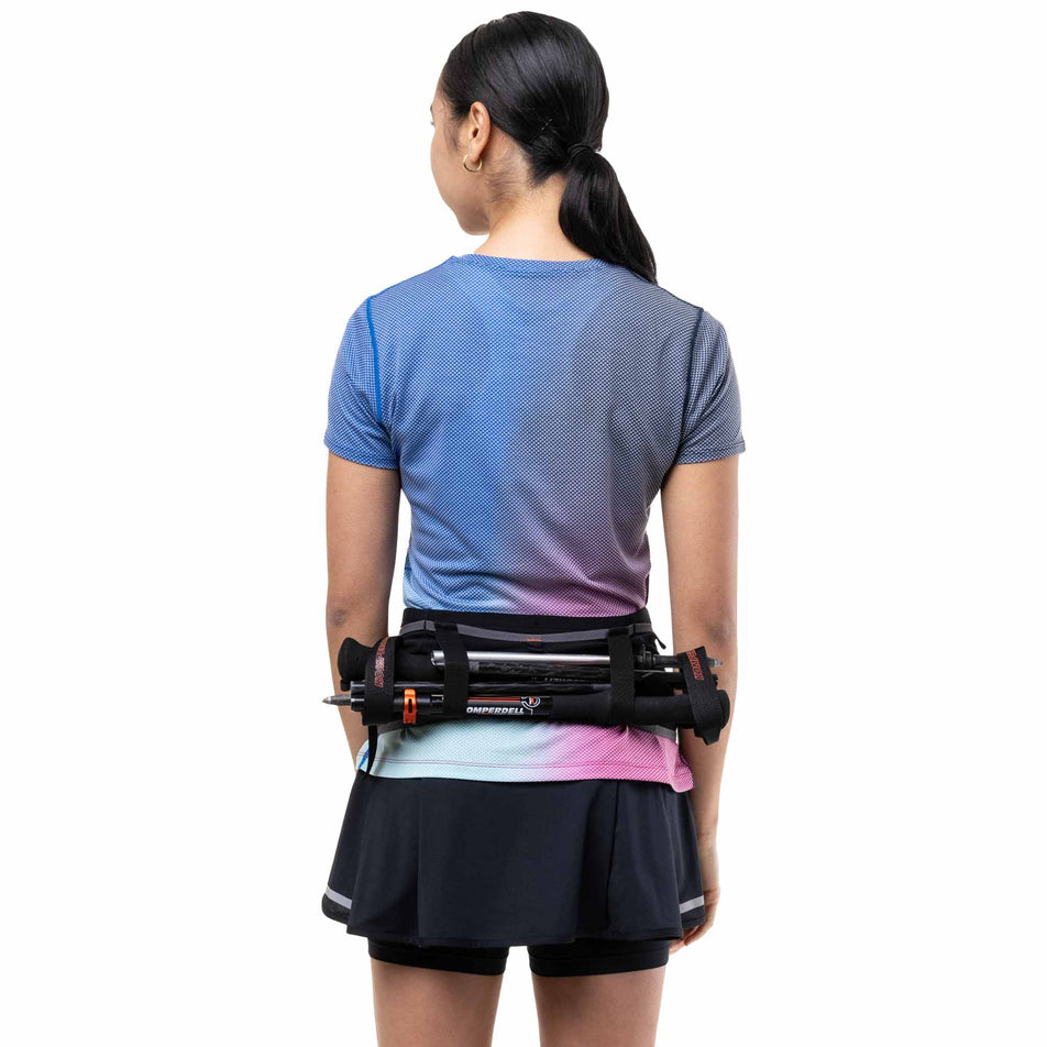 A model demonstrating running poles stored in the Ronhill Unisex Speed 360 in the Black/Ronhill Red colourway.