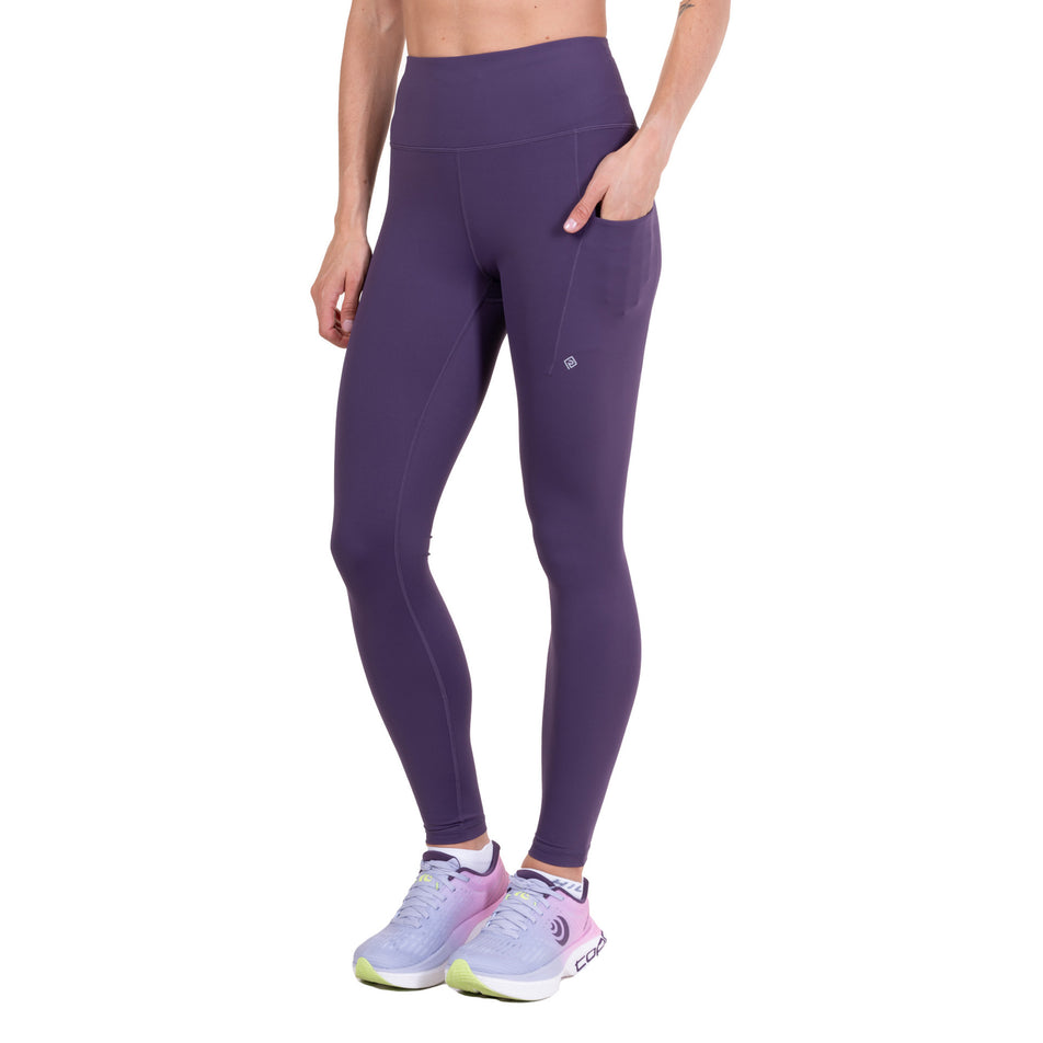 Front view of a model wearing the Ronhill Women's Tech Contour Tight in the Noir Iris colourway.