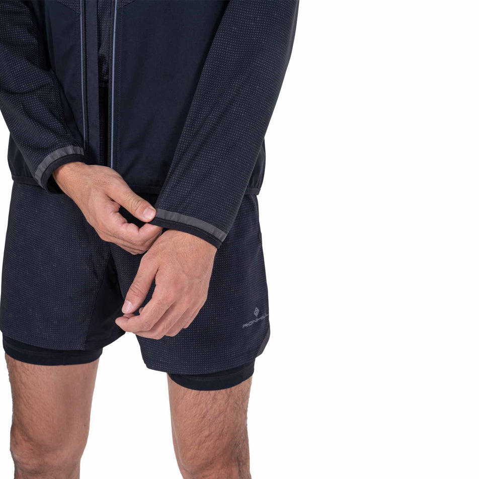 Close-up view of the sleeve of the Ronhill Men's Tech Reflect Lux Jacket in the Black/Reflect colourway.