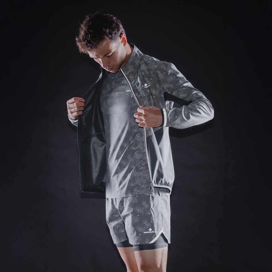 The reflective print on the Ronhill Men's Tech Reflect Lux Jacket in the Black/Reflect colourway.