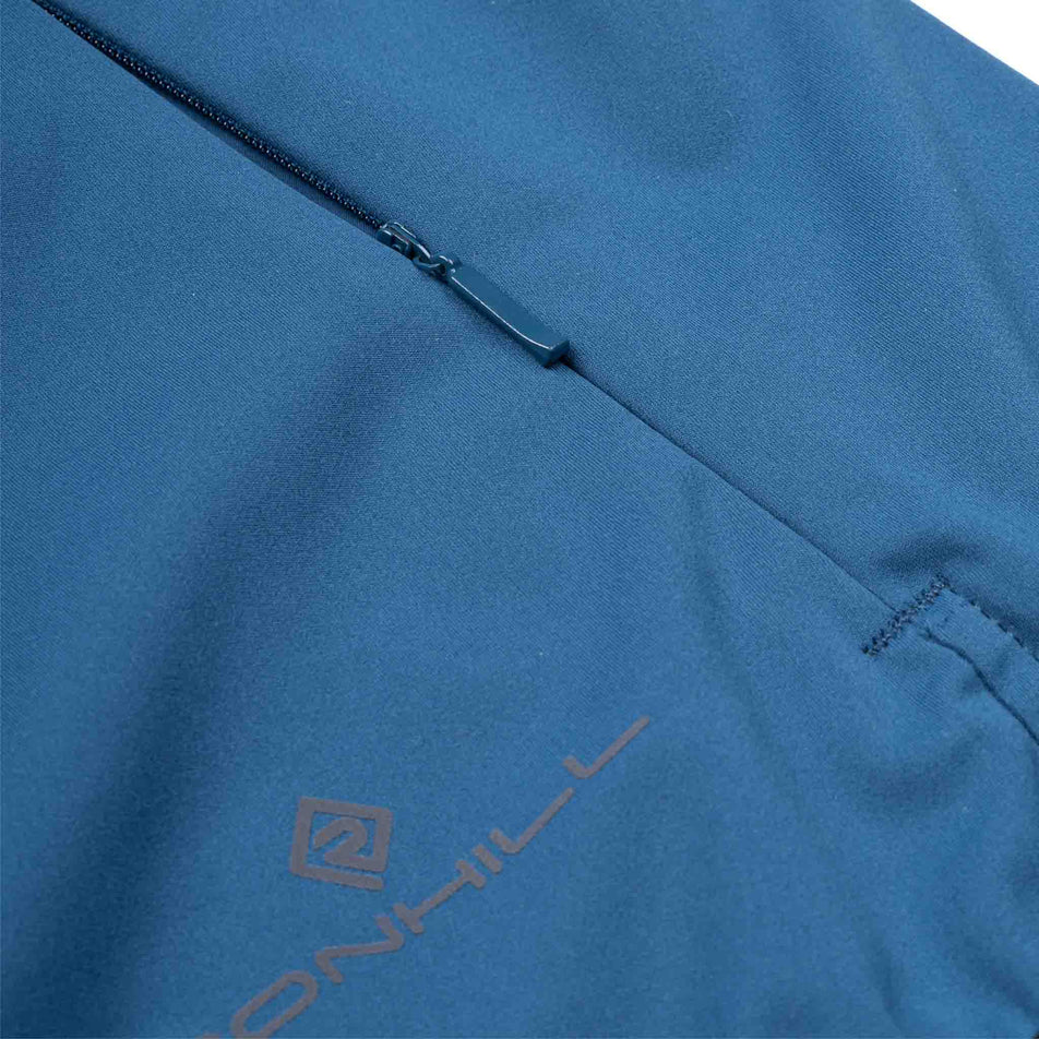 The zip pocket on the Ronhill Women's Tech Wind-Block Jacket in the Legion Blue colourway.
