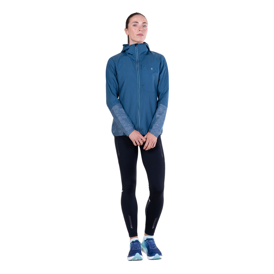 Front view of a model wearing the Ronhill Women's Tech Reflect Jacket in the Legion Blue/Reflect colourway.