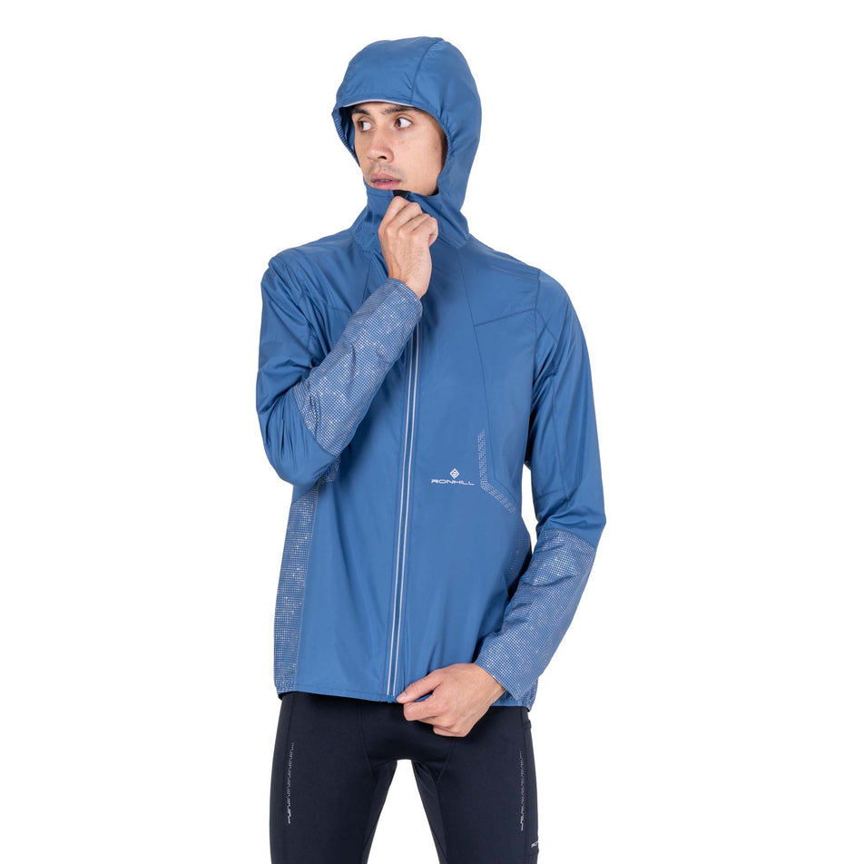 Front view of a model wearing the Ronhill Men's Tech Reflect Jacket in the Glacier/Reflect colourway.