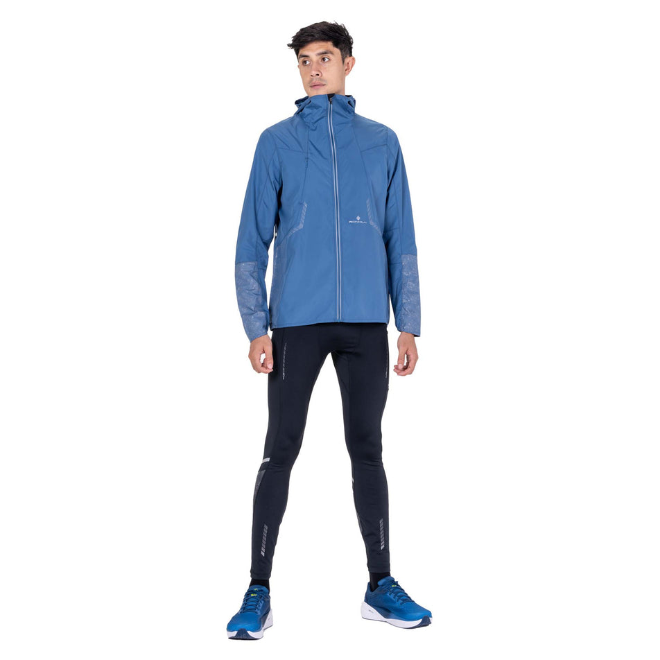 Front view of a model wearing the Ronhill Men's Tech Reflect Jacket in the Glacier/Reflect colourway.