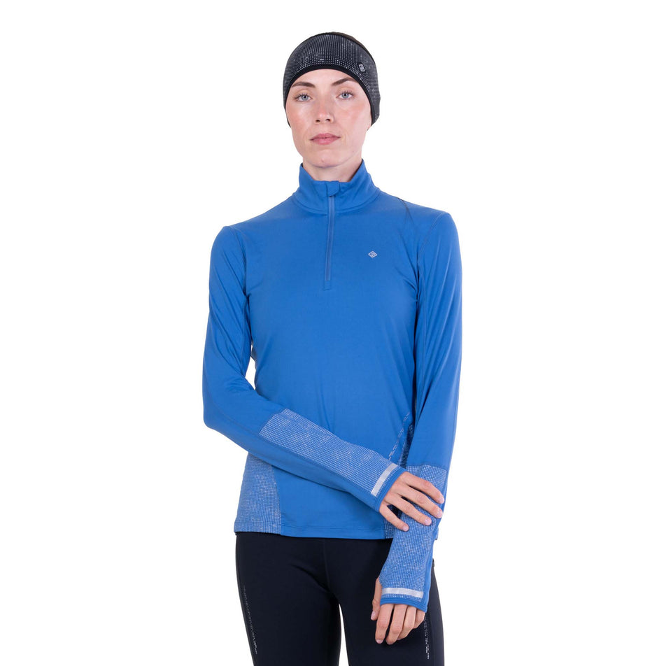 Front view of a model wearing the Ronhill Women's Tech Reflect 1/2 Zip in the Lumiere/Reflect colourway.
