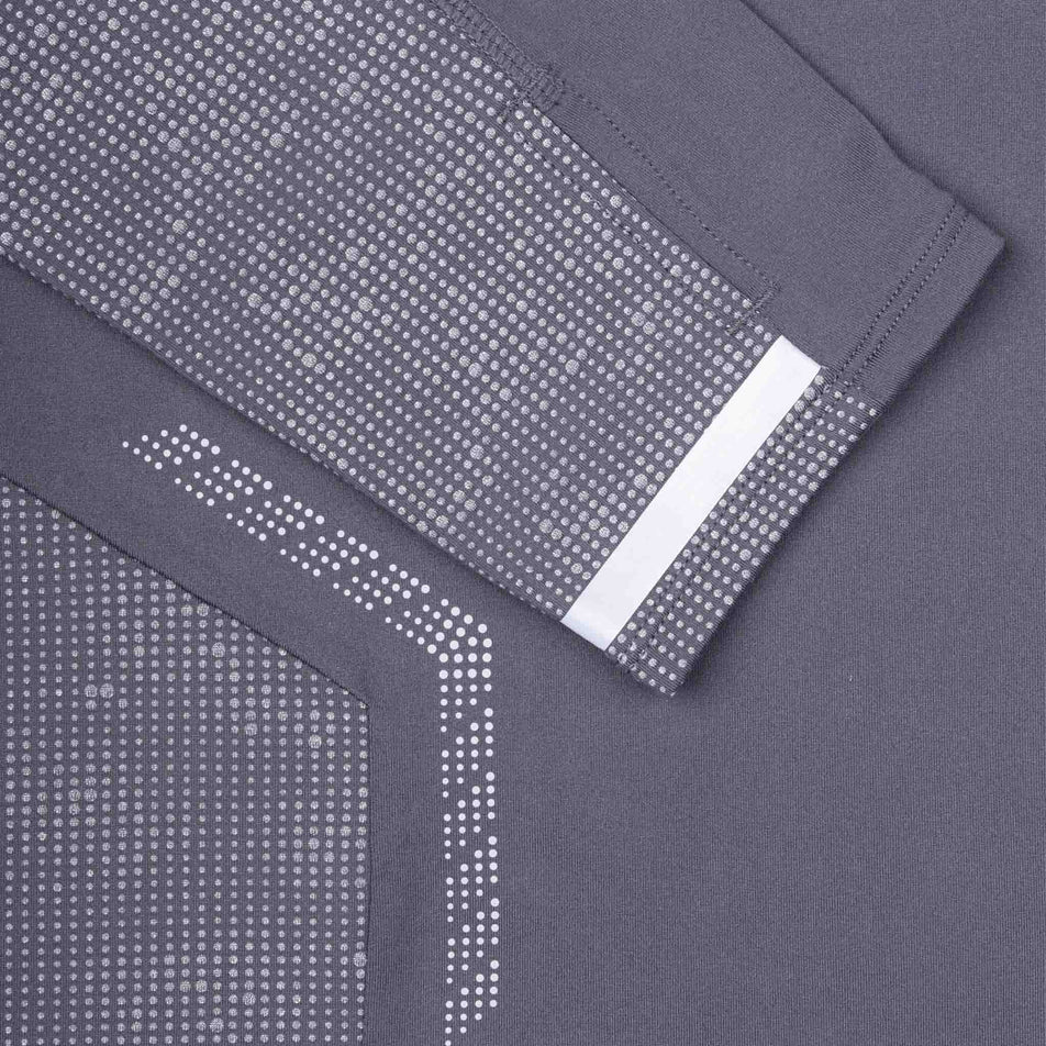 Close-up view of the reflective detail on the Ronhill Men's Tech Reflect 1/2 Zip in the Oxide/Reflect colourway.