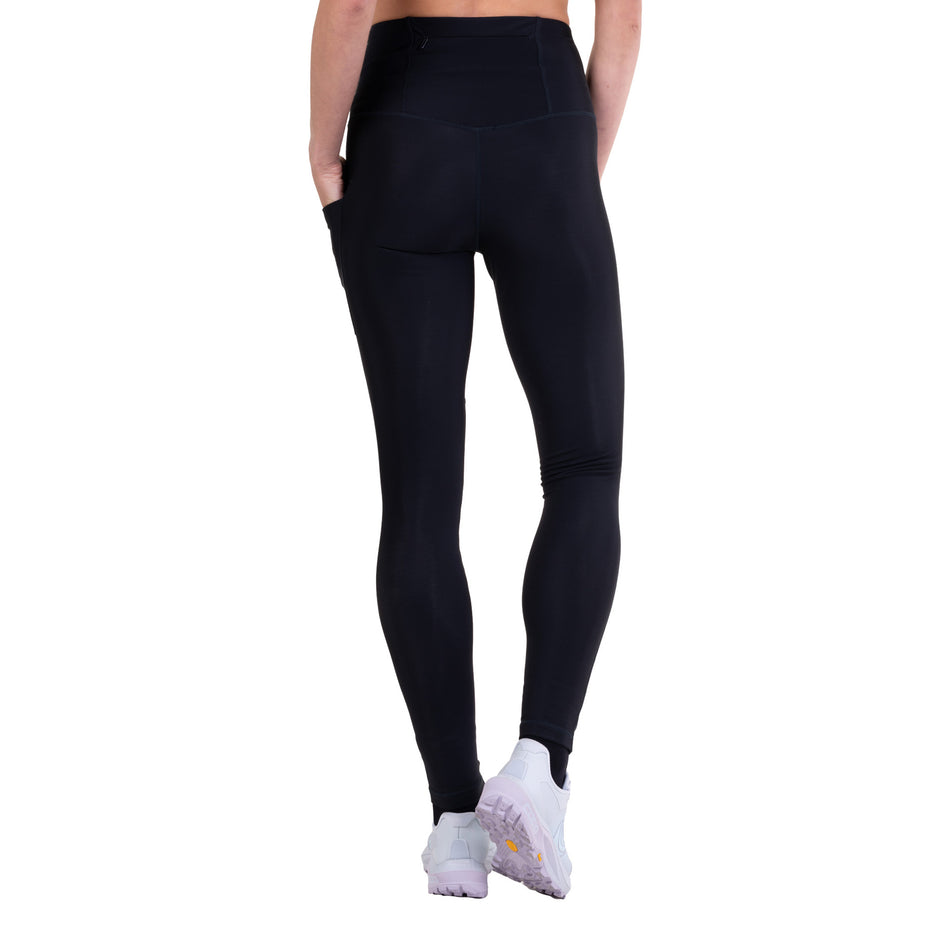 Back view of a model wearing the Ronhill Women's Tech Wind-Block Tight in the All Black colourway.