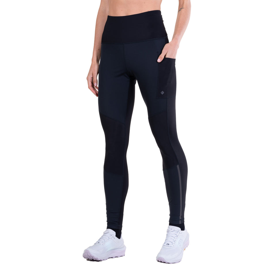 Front view of a model wearing the Ronhill Women's Tech Wind-Block Tight in the All Black colourway.