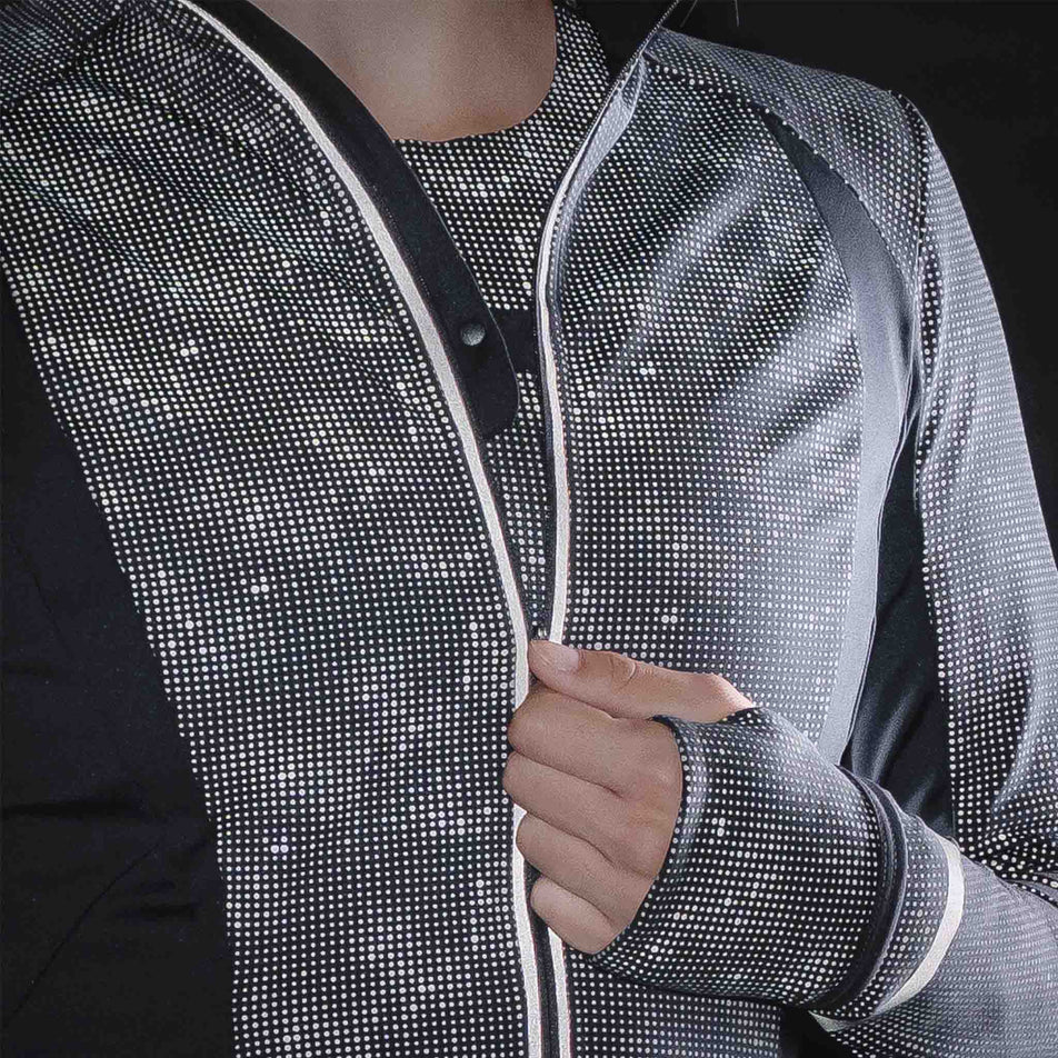 The reflective print on the Ronhill Women's Tech Reflect Lux Jacket in the Black/Reflect colourway.