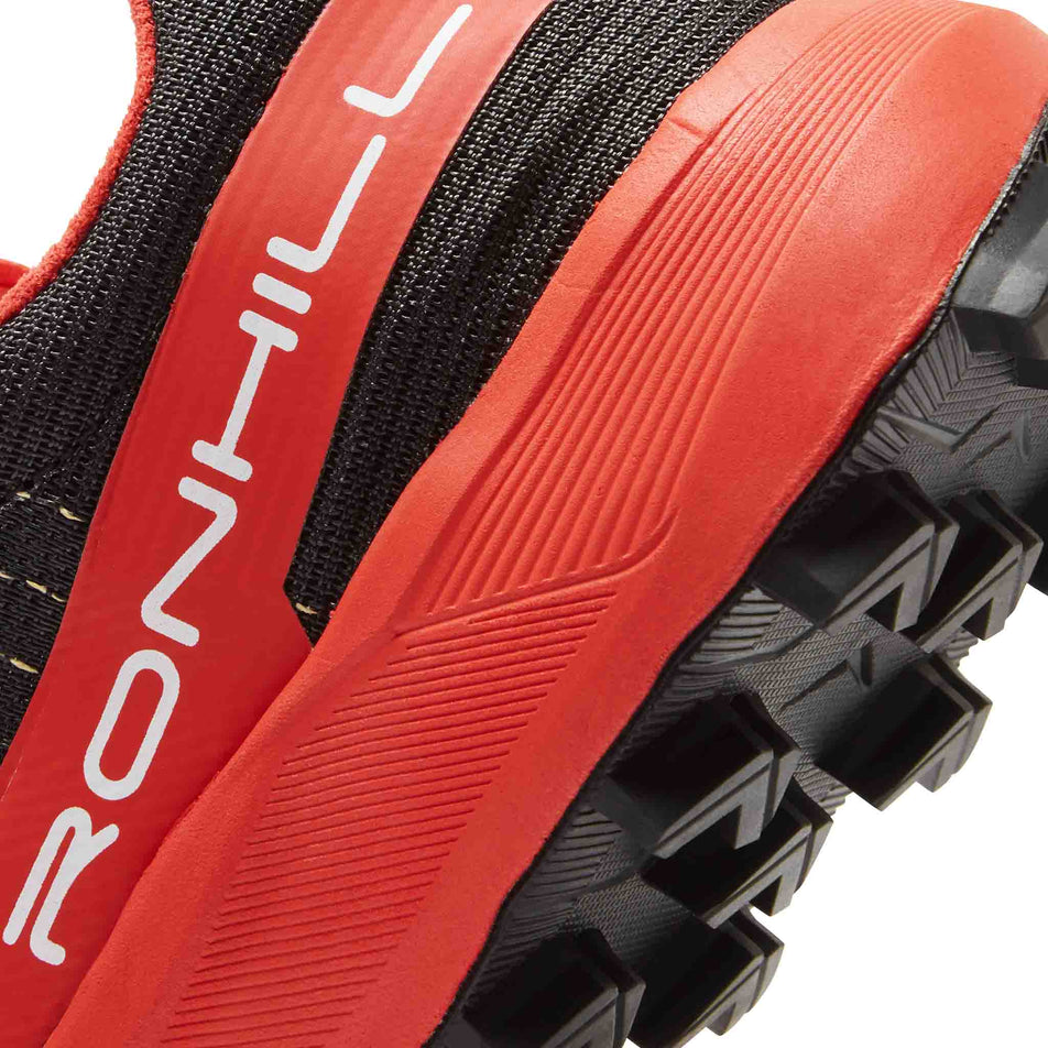 Lateral view of the rearfoot section of the left shoe from a pair of Ronhill Men's Reverence SL Running Shoes in the Black/Red colourway.