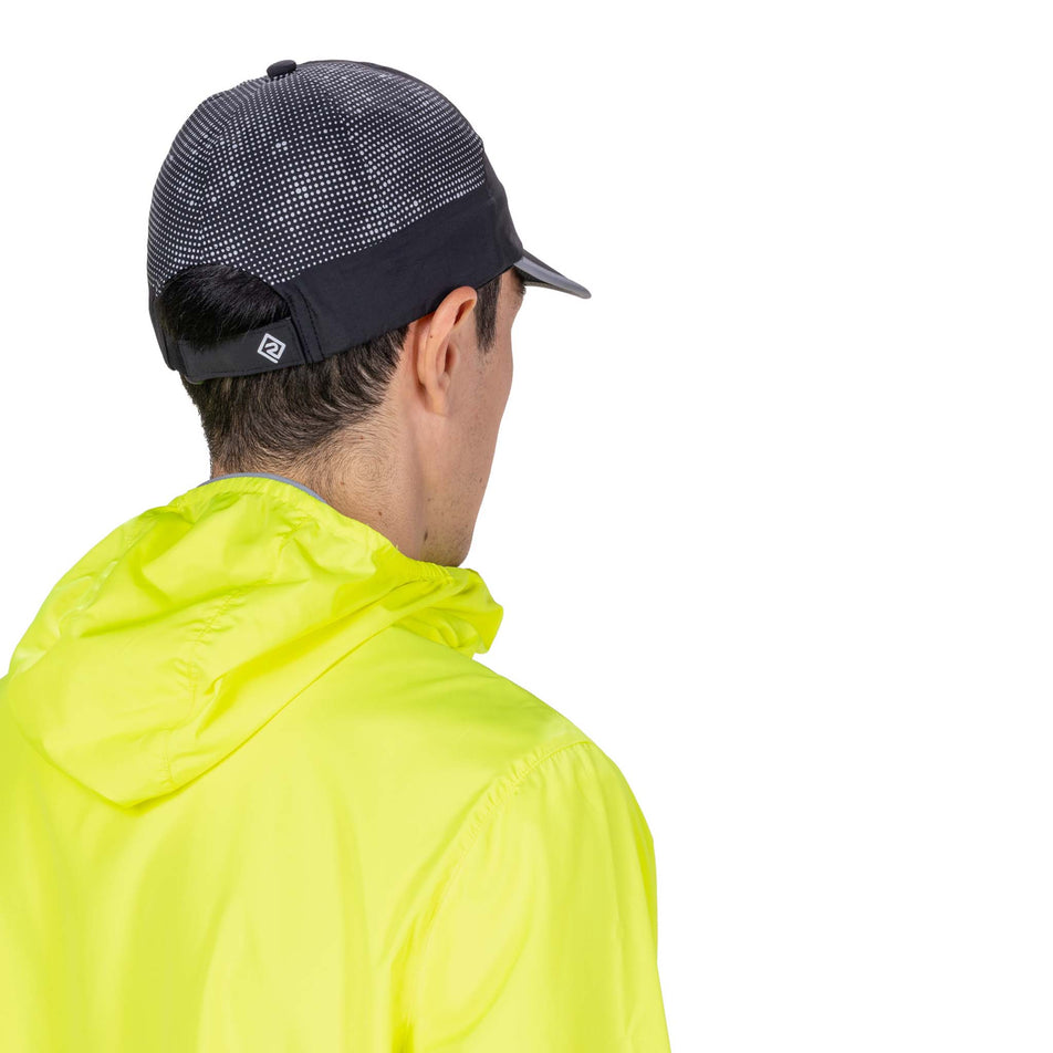 Back view of a model wearing the Ronhill Unisex Reflect Cap in the Black/Reflect colourway.