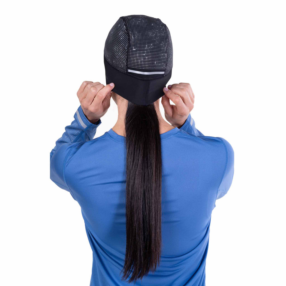 Back view of a model wearing the Ronhill Unisex Reflect Beanie in the Black/Reflect colourway.